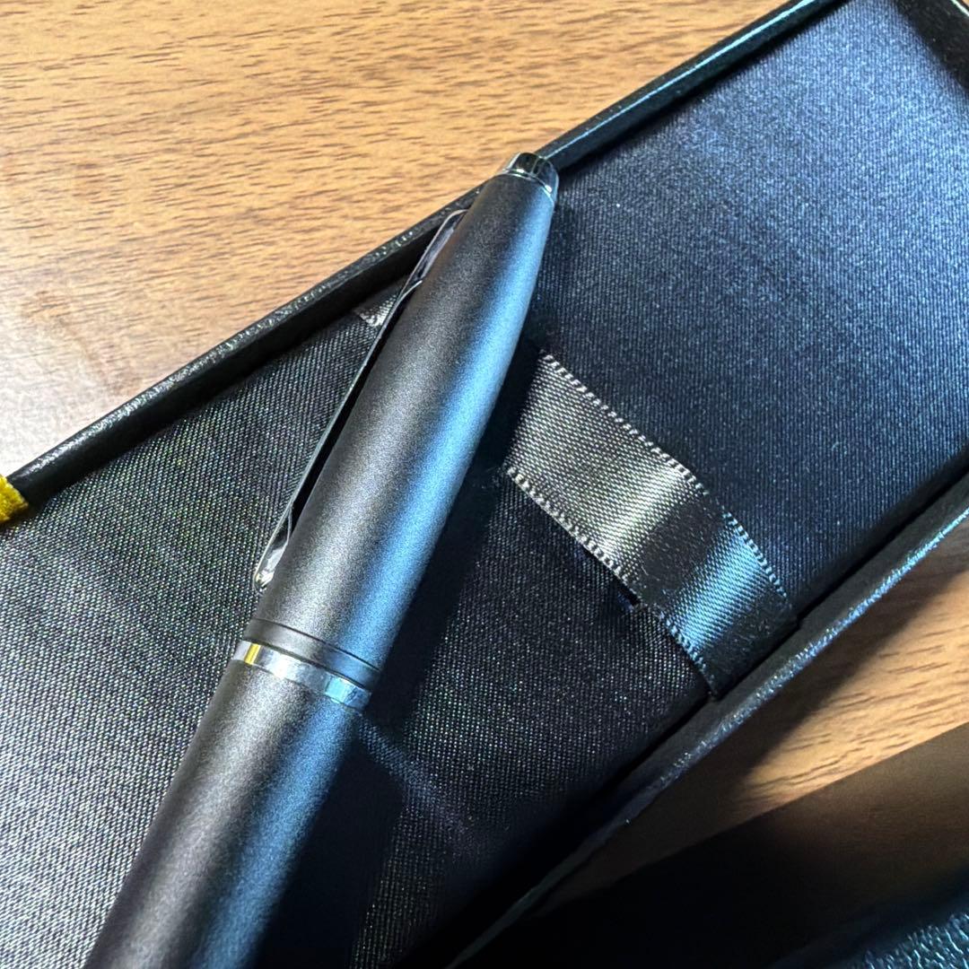 CROSS ballpoint pen in matte black finish with its dedicated protective case opened beside it