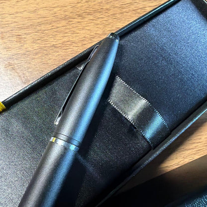 CROSS ballpoint pen in matte black finish with its dedicated protective case opened beside it