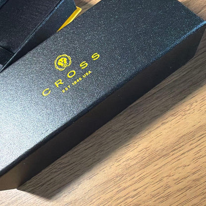 CROSS ballpoint pen in matte black finish with its dedicated protective case opened beside it