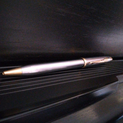 Cross Century II oil-based ballpoint pen with silver and gold brass body and medium black ink