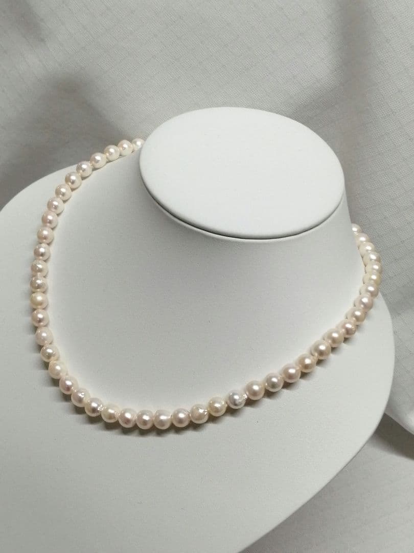 Akoya pearl necklace with white and cream semi-round to baroque pearls and silver hook clasp