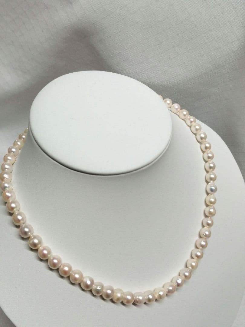Akoya pearl necklace with white and cream semi-round to baroque pearls and silver hook clasp