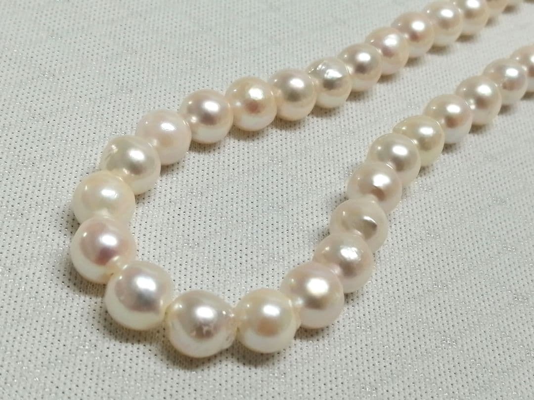 Akoya pearl necklace with white and cream semi-round to baroque pearls and silver hook clasp