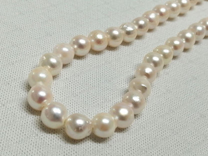 Akoya pearl necklace with white and cream semi-round to baroque pearls and silver hook clasp