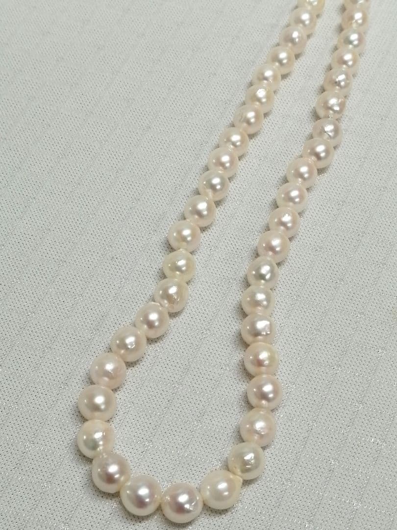 Akoya pearl necklace with white and cream semi-round to baroque pearls and silver hook clasp