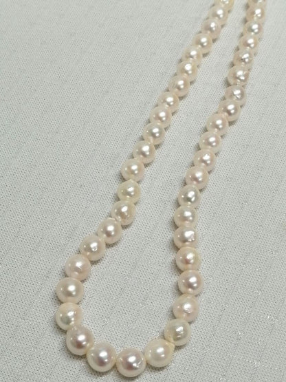 Akoya pearl necklace with white and cream semi-round to baroque pearls and silver hook clasp