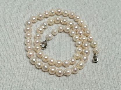 Akoya pearl necklace with white and cream semi-round to baroque pearls and silver hook clasp