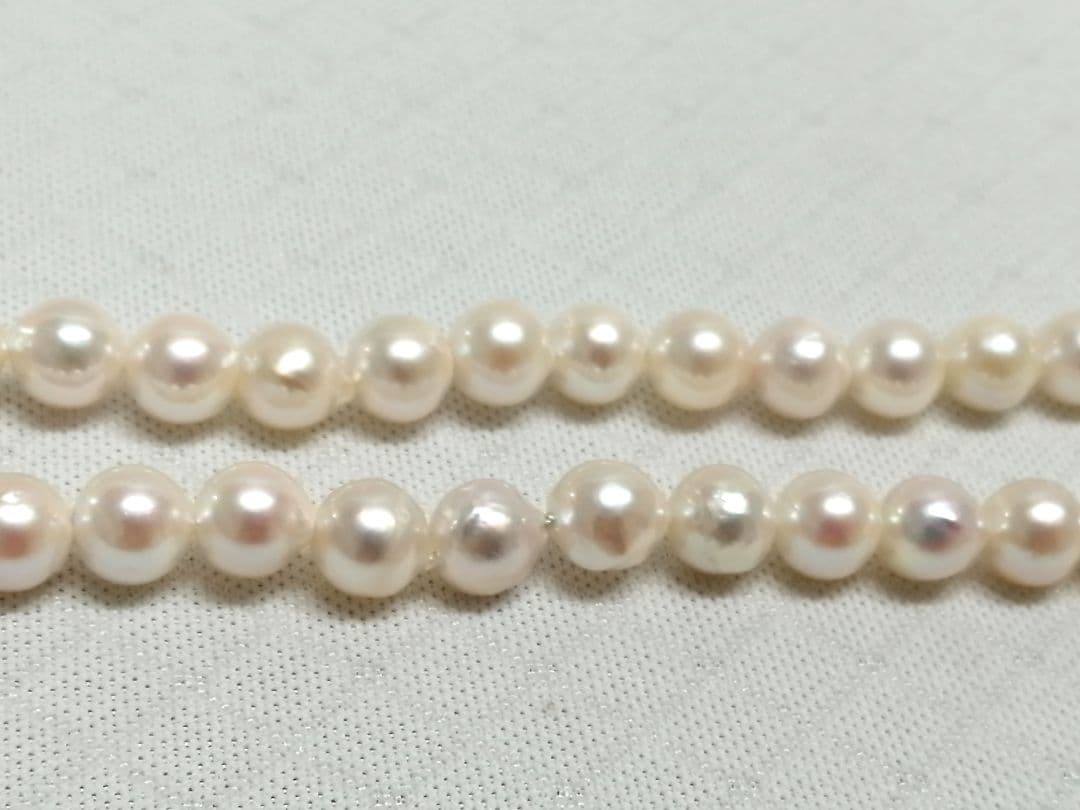 Akoya pearl necklace with white and cream semi-round to baroque pearls and silver hook clasp