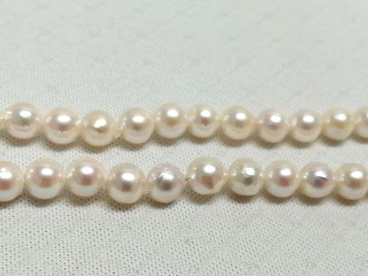 Akoya pearl necklace with white and cream semi-round to baroque pearls and silver hook clasp