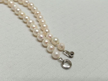Akoya pearl necklace with white and cream semi-round to baroque pearls and silver hook clasp