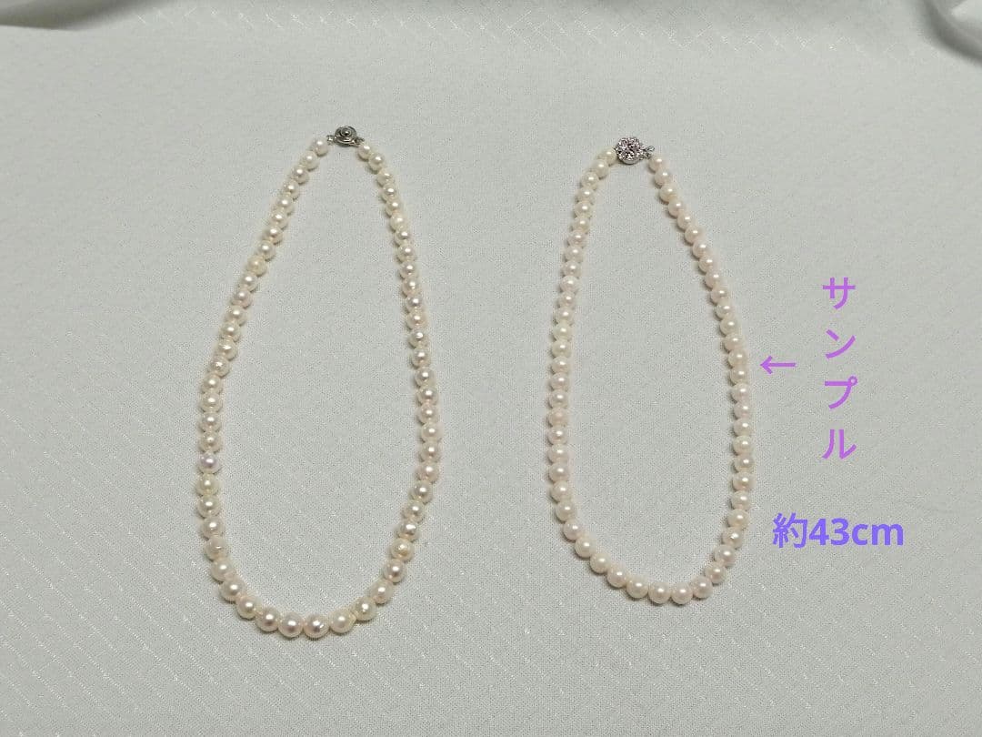 Akoya pearl necklace with white and cream semi-round to baroque pearls and silver hook clasp