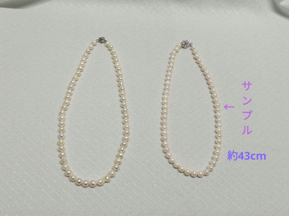 Akoya pearl necklace with white and cream semi-round to baroque pearls and silver hook clasp