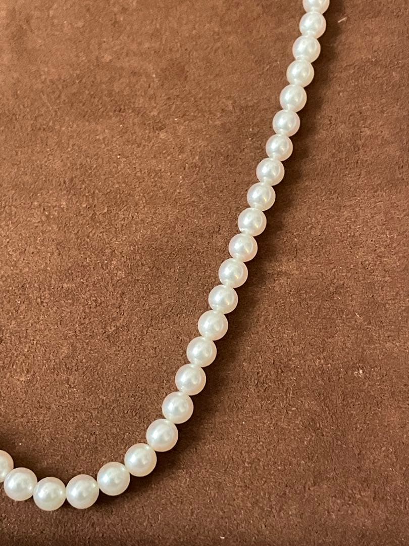 Close-up of Mikimoto pearl necklace with 3.5mm pearls and 36cm length on a white background