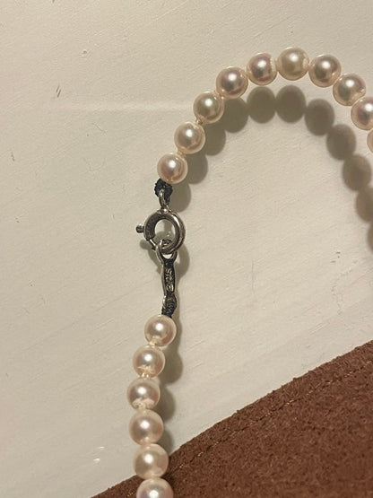 Close-up of Mikimoto pearl necklace with 3.5mm pearls and 36cm length on a white background