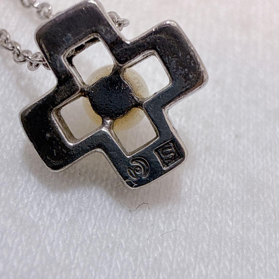 Tasaki silver cross necklace featuring a single pearl pendant on an adjustable metal chain length 39 to 42.5 cm