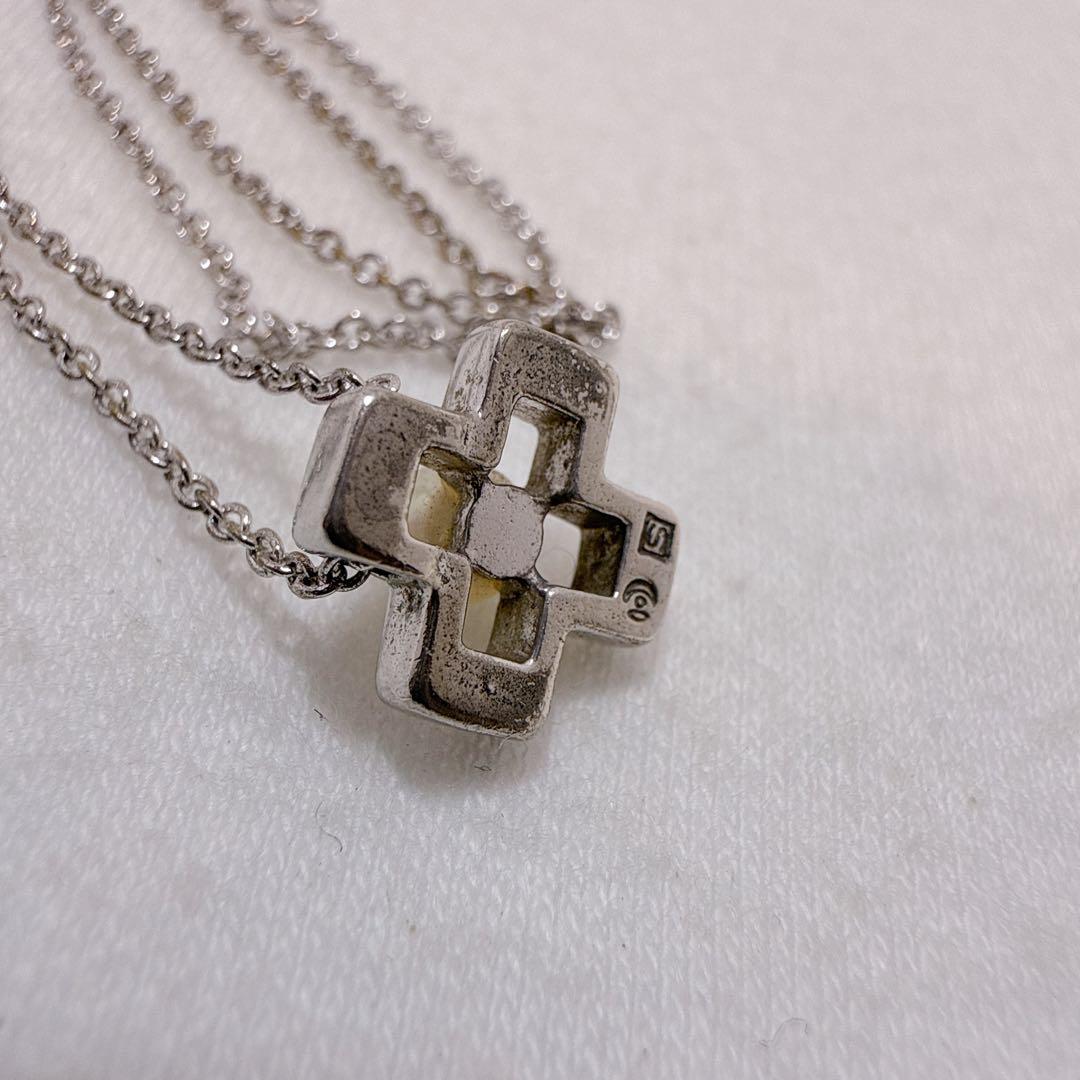 Tasaki silver cross necklace featuring a single pearl pendant on an adjustable metal chain length 39 to 42.5 cm