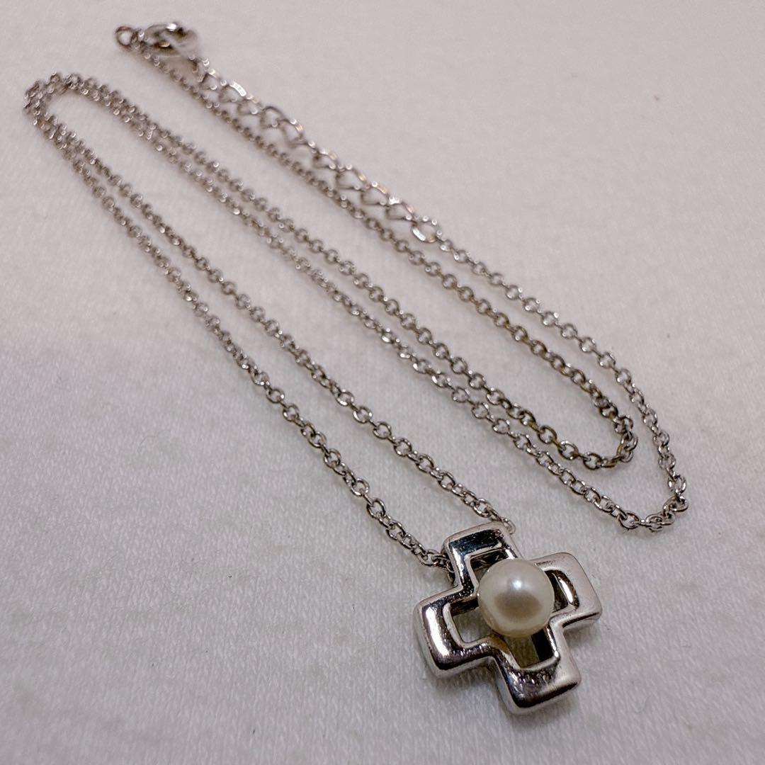 Tasaki silver cross necklace featuring a single pearl pendant on an adjustable metal chain length 39 to 42.5 cm