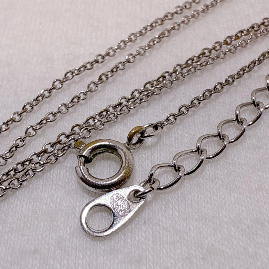 Tasaki silver cross necklace featuring a single pearl pendant on an adjustable metal chain length 39 to 42.5 cm
