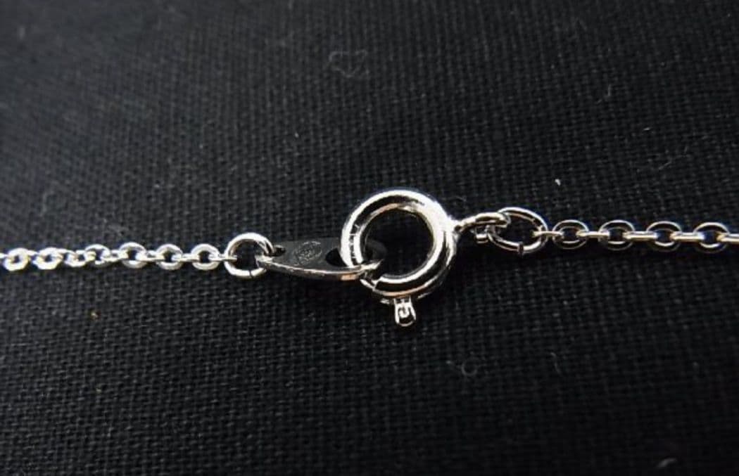 Tasaki pearl necklace with 6mm pearls and 16-inch length displayed on a white background
