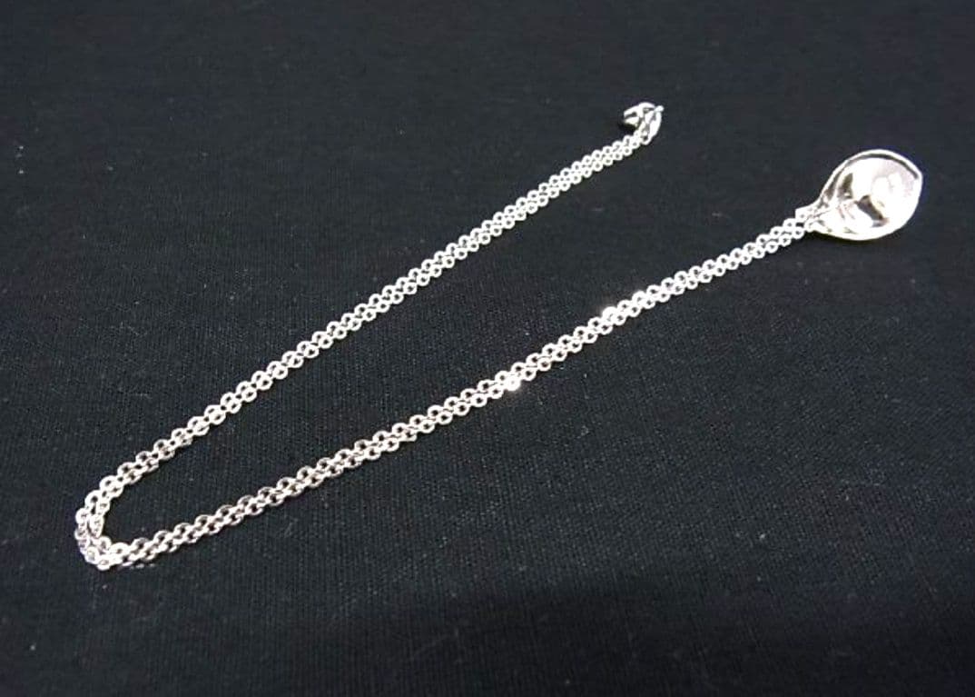 Tasaki pearl necklace with 6mm pearls and 16-inch length displayed on a white background