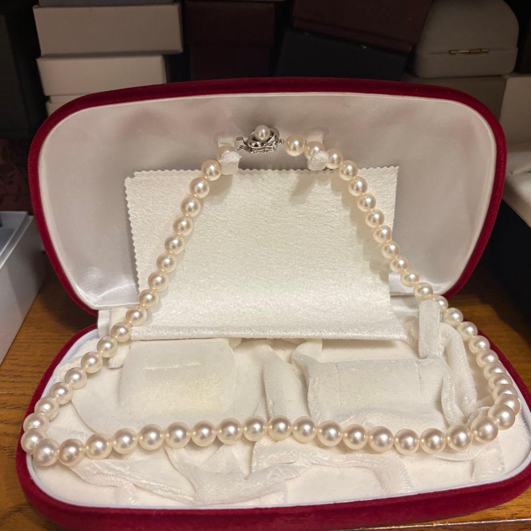 Tasaki Akoya pearl necklace with 8mm pearls and silver fittings laid out flat