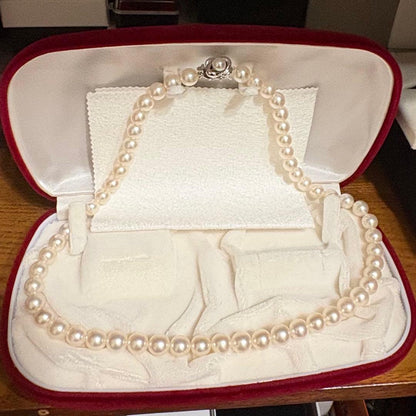 Tasaki Akoya pearl necklace with 8mm pearls and silver fittings laid out flat