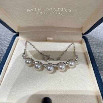 Mikimoto necklace featuring 5 pearls on silver chain with a blue dedicated case