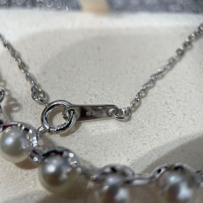 Mikimoto necklace featuring 5 pearls on silver chain with a blue dedicated case
