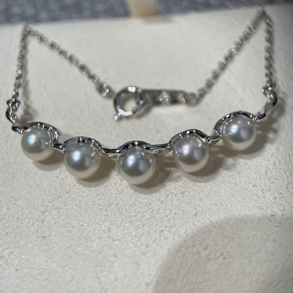 Mikimoto necklace featuring 5 pearls on silver chain with a blue dedicated case