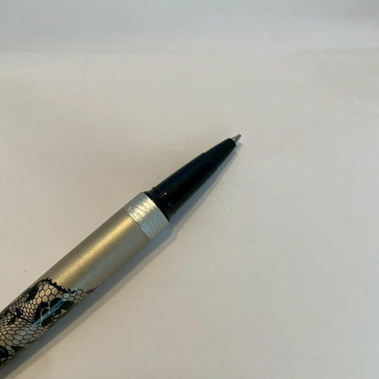Waterman Audace ballpoint pen with a rose pattern cap, displayed uncapped showing its sleek design