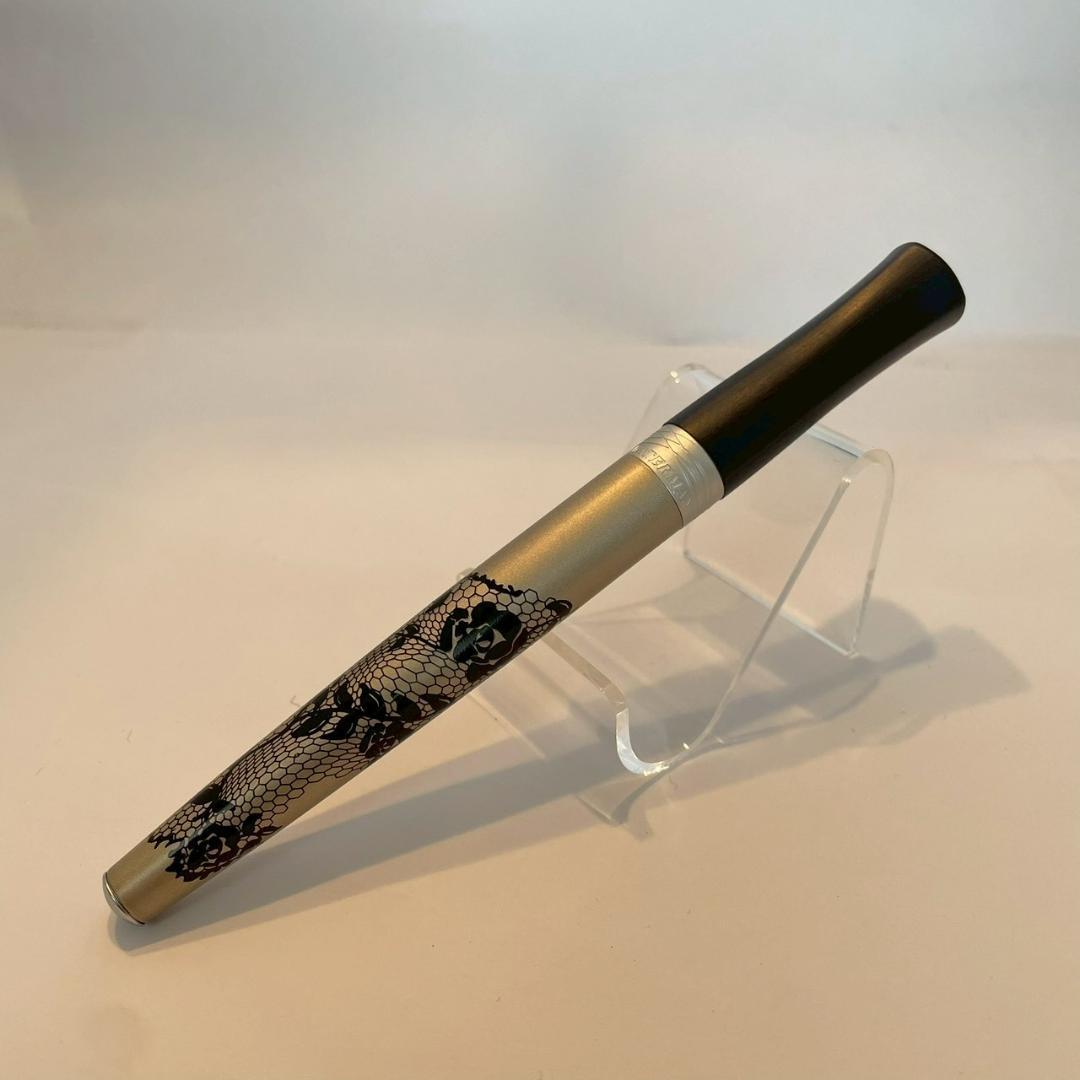Waterman Audace ballpoint pen with a rose pattern cap, displayed uncapped showing its sleek design