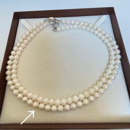 High-quality Akoya pearl necklace and earring set with 7.5mm white round pearls on a white background