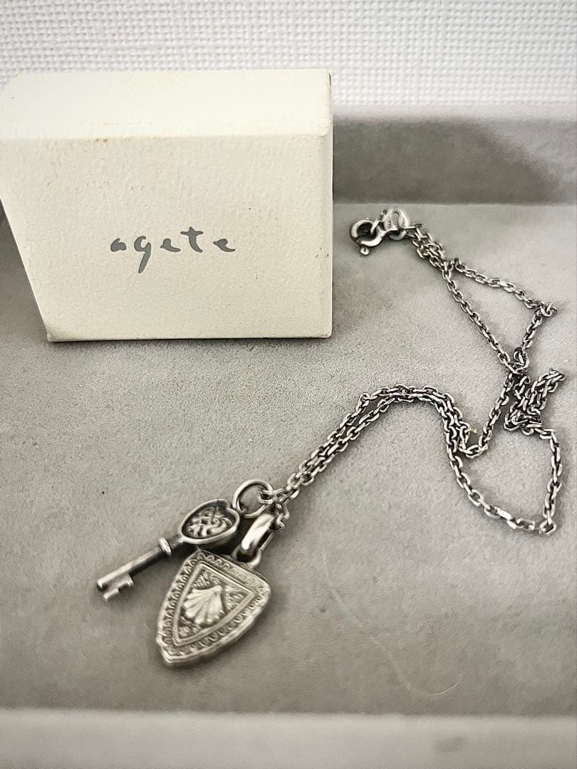 Agete silver necklace with key and emblem charms, 400mm length, slight blackening finish