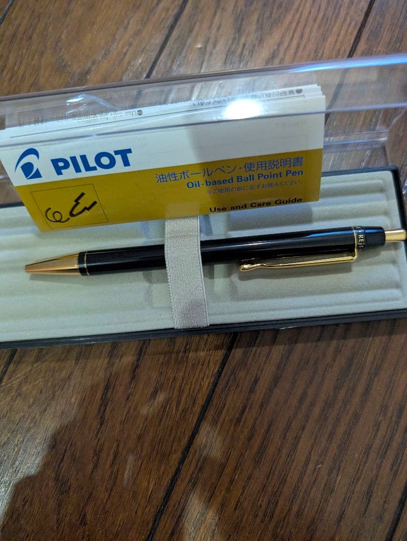 PILOT Oil-Based Ballpoint Pen in black with gold clip and tip shown with instruction manual