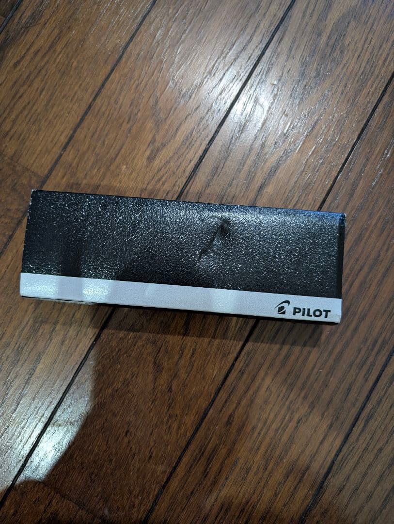 PILOT Oil-Based Ballpoint Pen in black with gold clip and tip shown with instruction manual