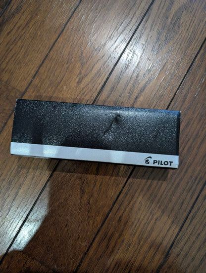 PILOT Oil-Based Ballpoint Pen in black with gold clip and tip shown with instruction manual