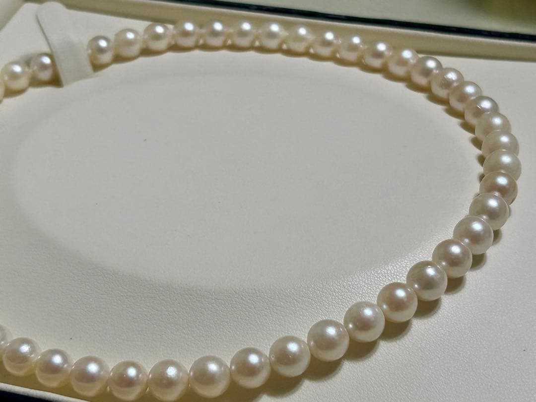 Close-up of Akoya pearl necklace with 8.4mm pearls measuring 42cm in length on a white background