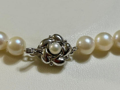 Close-up of Akoya pearl necklace with 8.4mm pearls measuring 42cm in length on a white background