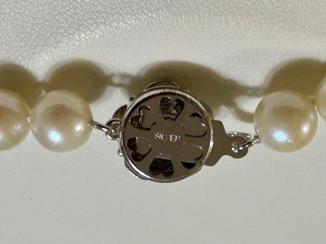 Close-up of Akoya pearl necklace with 8.4mm pearls measuring 42cm in length on a white background