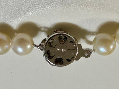 Close-up of Akoya pearl necklace with 8.4mm pearls measuring 42cm in length on a white background