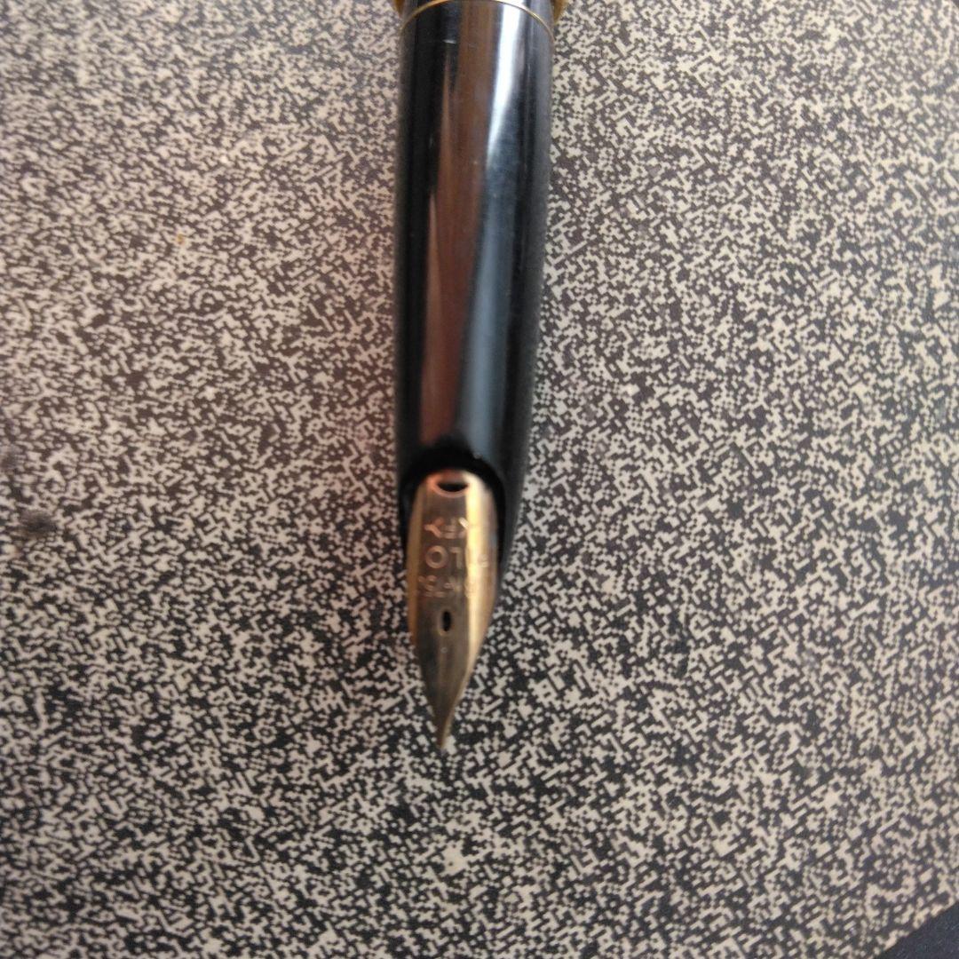 Pilot fountain pen with 18K gold fine nib and brown leather wrapped body on white background