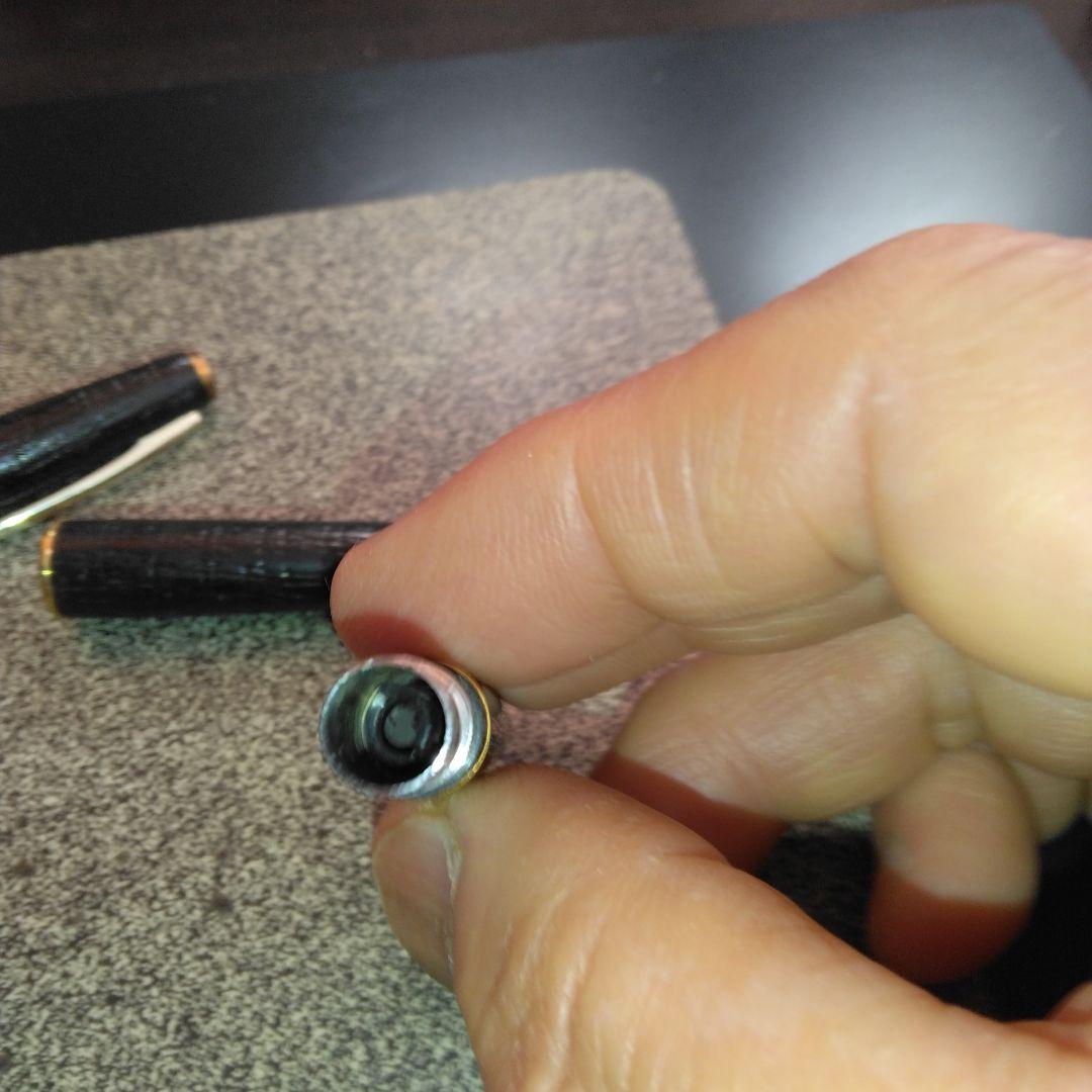 Pilot fountain pen with 18K gold fine nib and brown leather wrapped body on white background