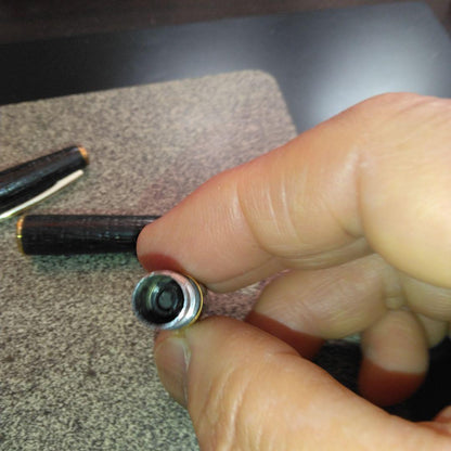 Pilot fountain pen with 18K gold fine nib and brown leather wrapped body on white background