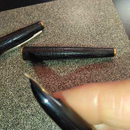 Pilot fountain pen with 18K gold fine nib and brown leather wrapped body on white background