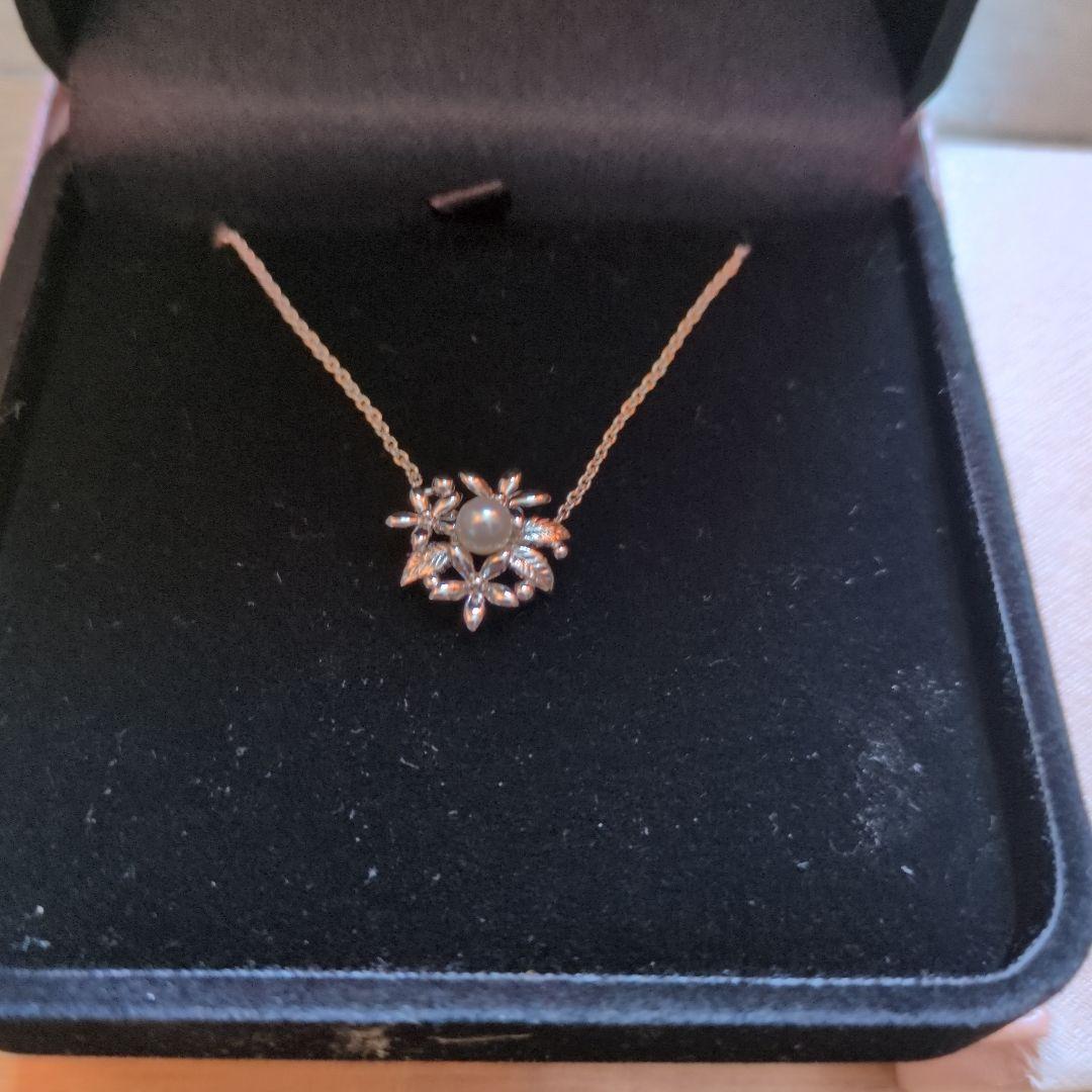 TASAKI flower-shaped pendant necklace displayed with original box on a white background