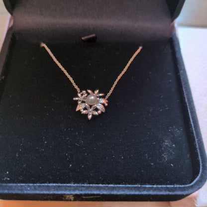 TASAKI flower-shaped pendant necklace displayed with original box on a white background