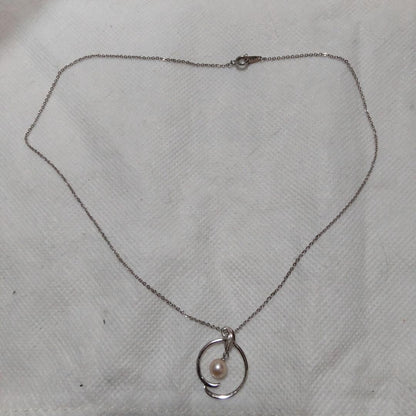 Elegant Mikimoto pearl necklace with gold chain on white background