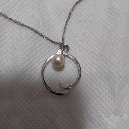 Elegant Mikimoto pearl necklace with gold chain on white background