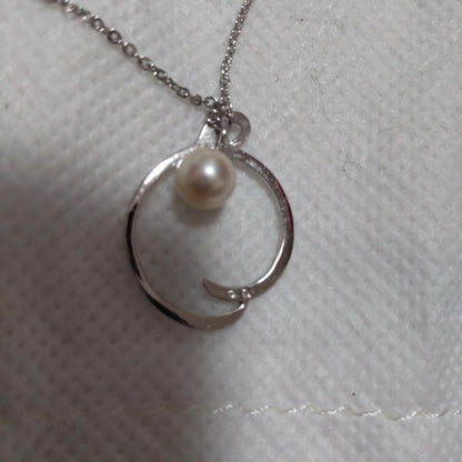 Elegant Mikimoto pearl necklace with gold chain on white background