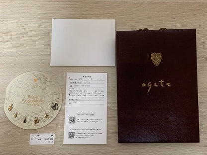 Agete 33rd anniversary charm accessory with intricate design, shown on a white background